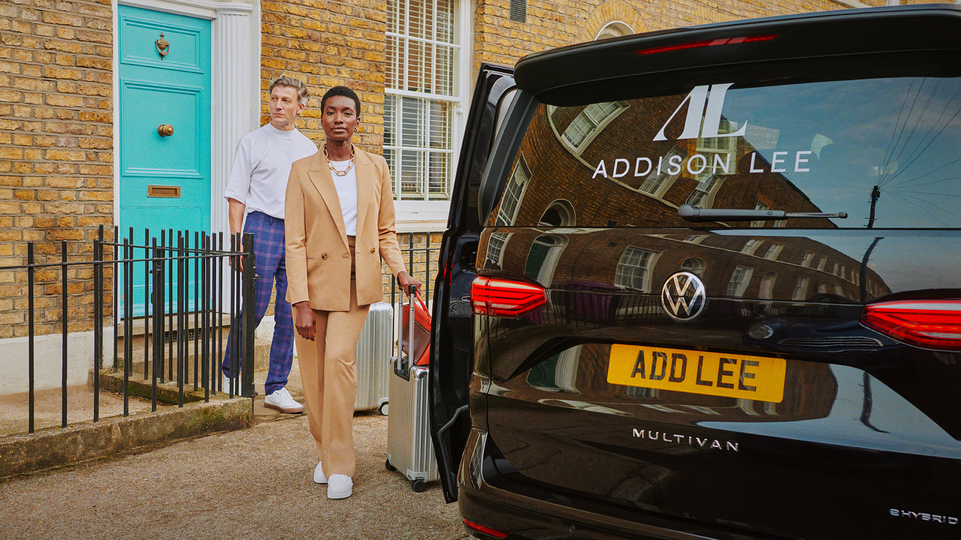 Addison Lee multivan van in and couple with suitcase