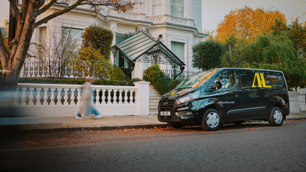Addison Lee courier van parked in a leafy street
