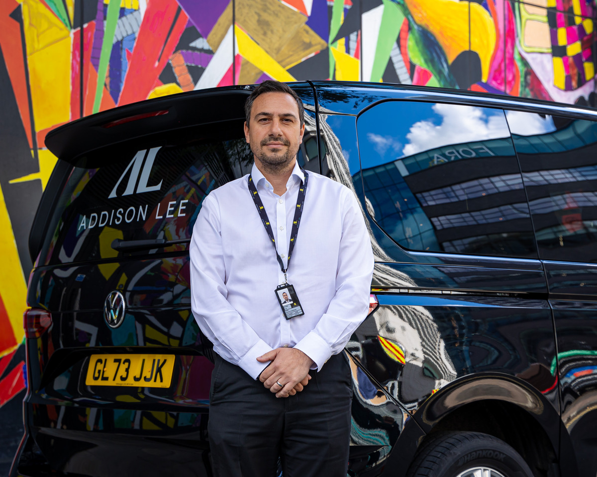 Addison Lee driver standing in front of car