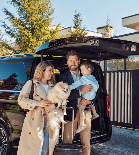 large black van with family and dog standing in front of it