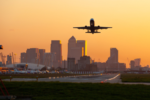london airport plane flying over