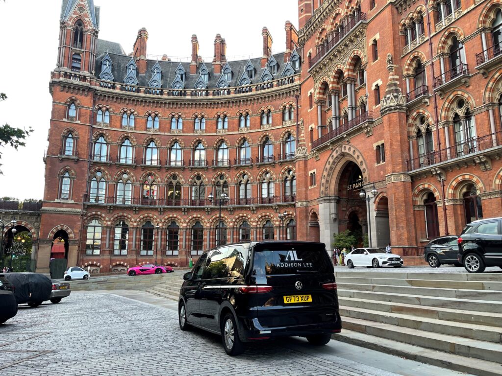 Addison Lee multivan parked in front of Kings Cross St Pancras station